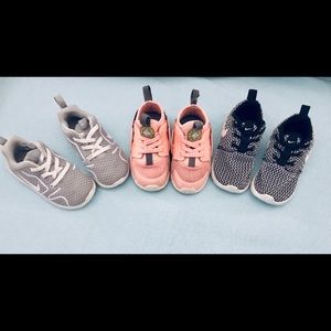 3 pairs of girl’s toddler sized 7 Nike sneakers.